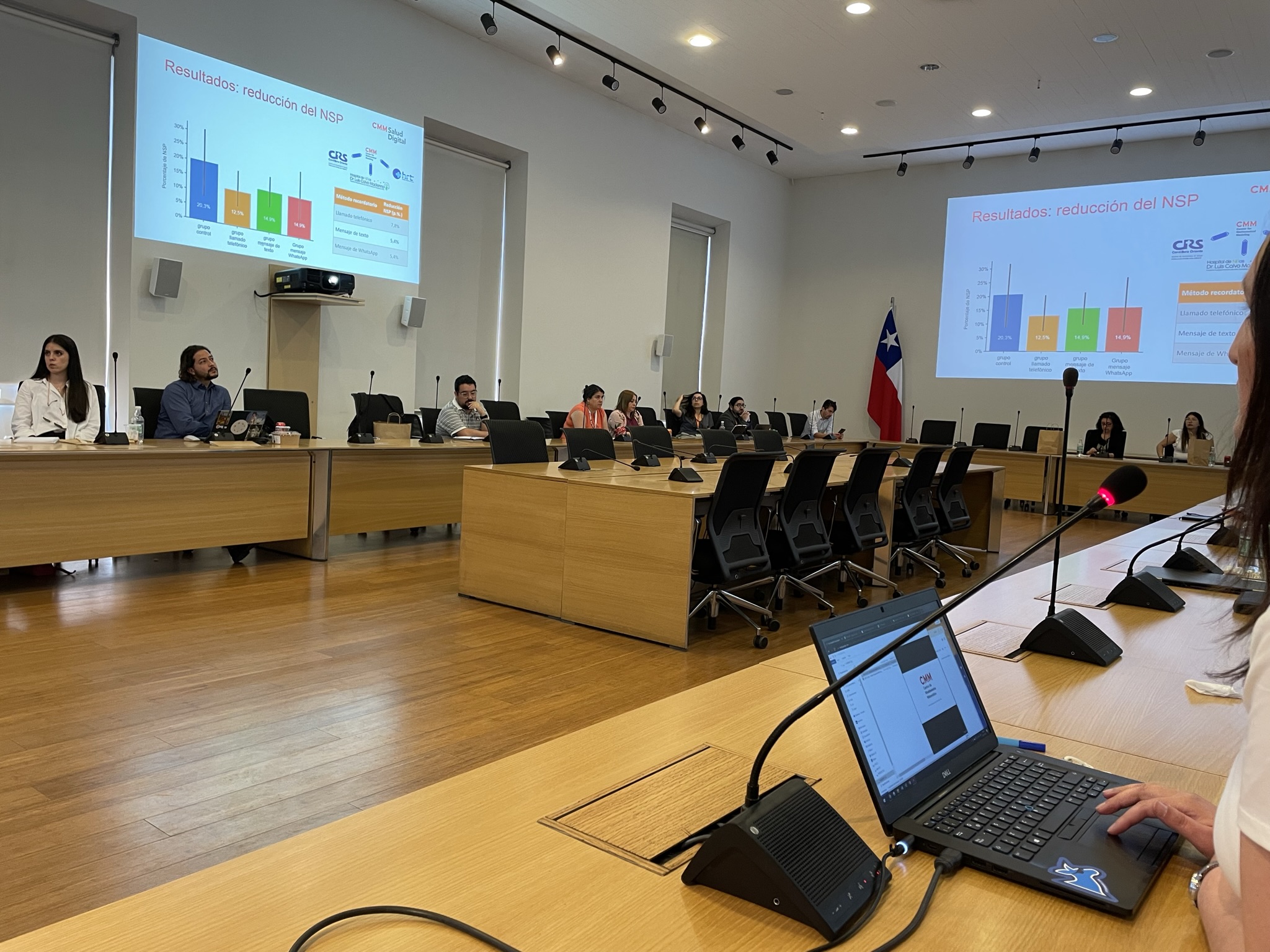 Photo of Chilean watch party- computers and screens, people talking