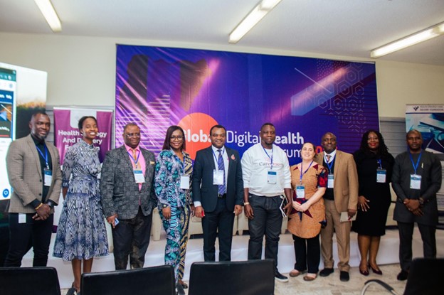 Panelists and Participants in front of the GDHF Signage